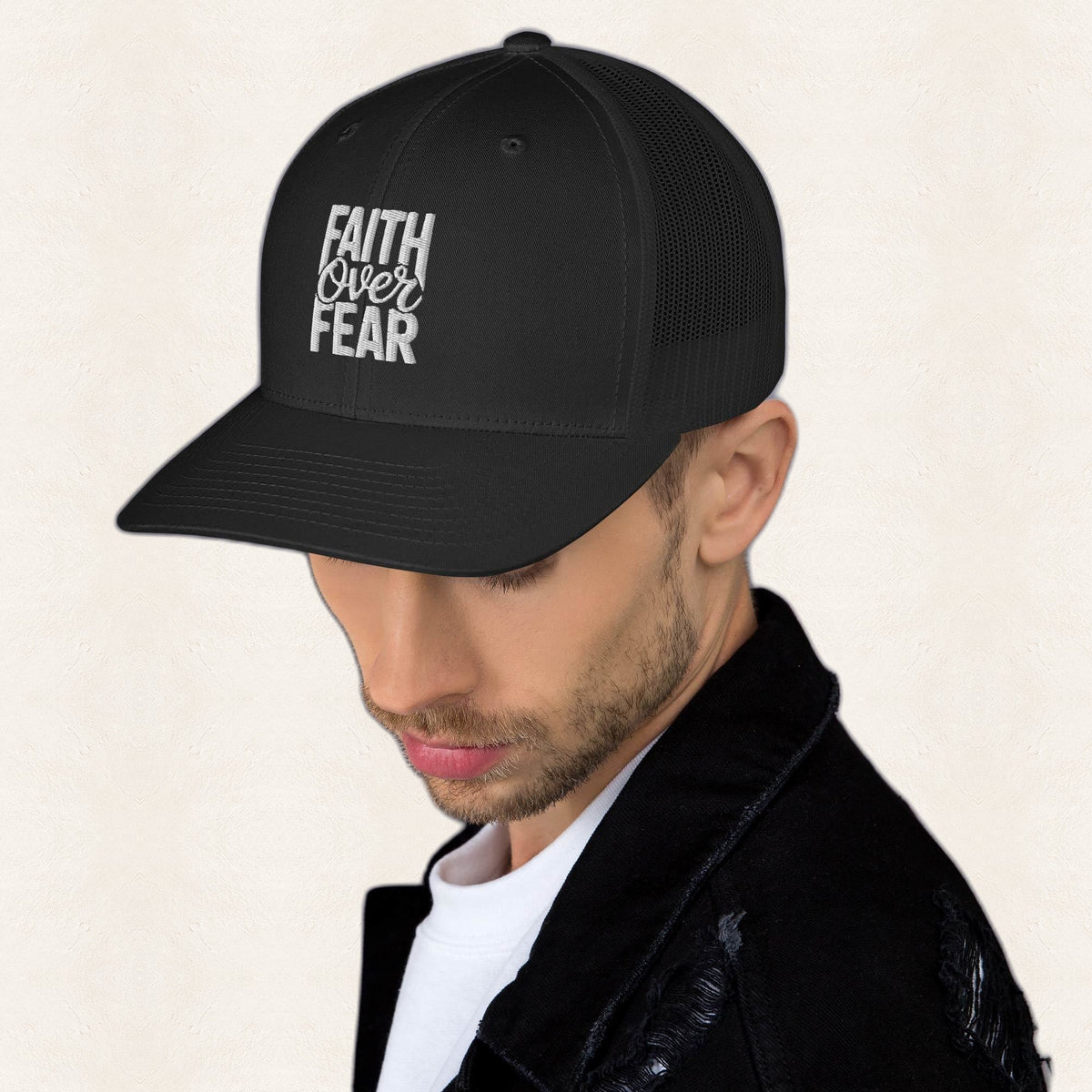 Faith Over Fear Black Embroidered Trucker Hat — original product and design — warm ivory background