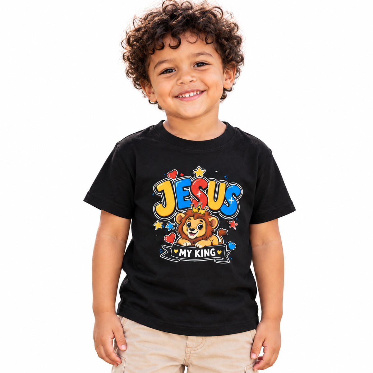 Boy wearing the black Jesus My King toddler T-shirt on a white background