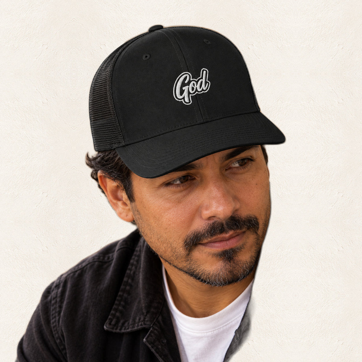 God Embroidered Trucker Hat — original product and design — warm ivory background