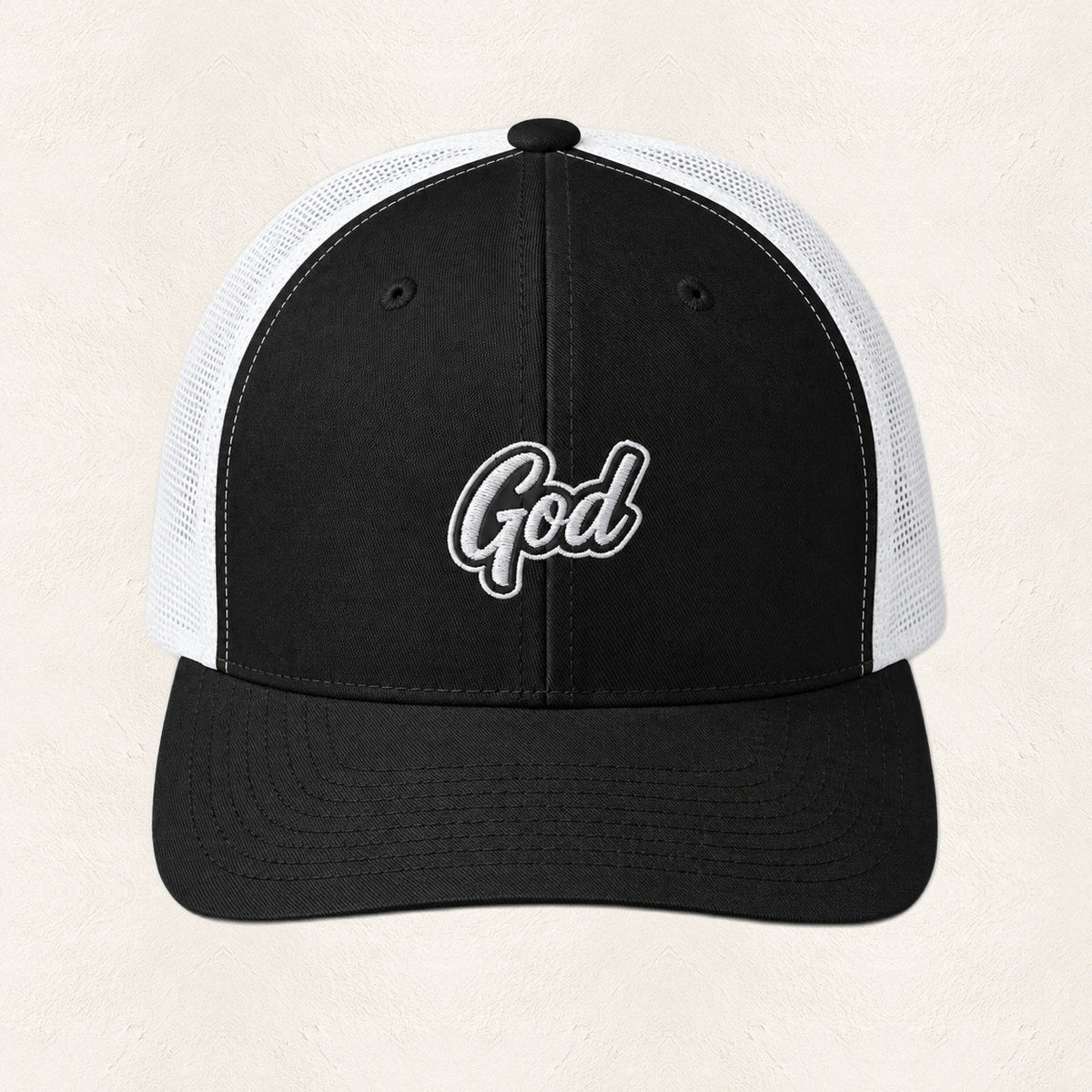 God Embroidered Trucker Hat — original product and design — warm ivory background