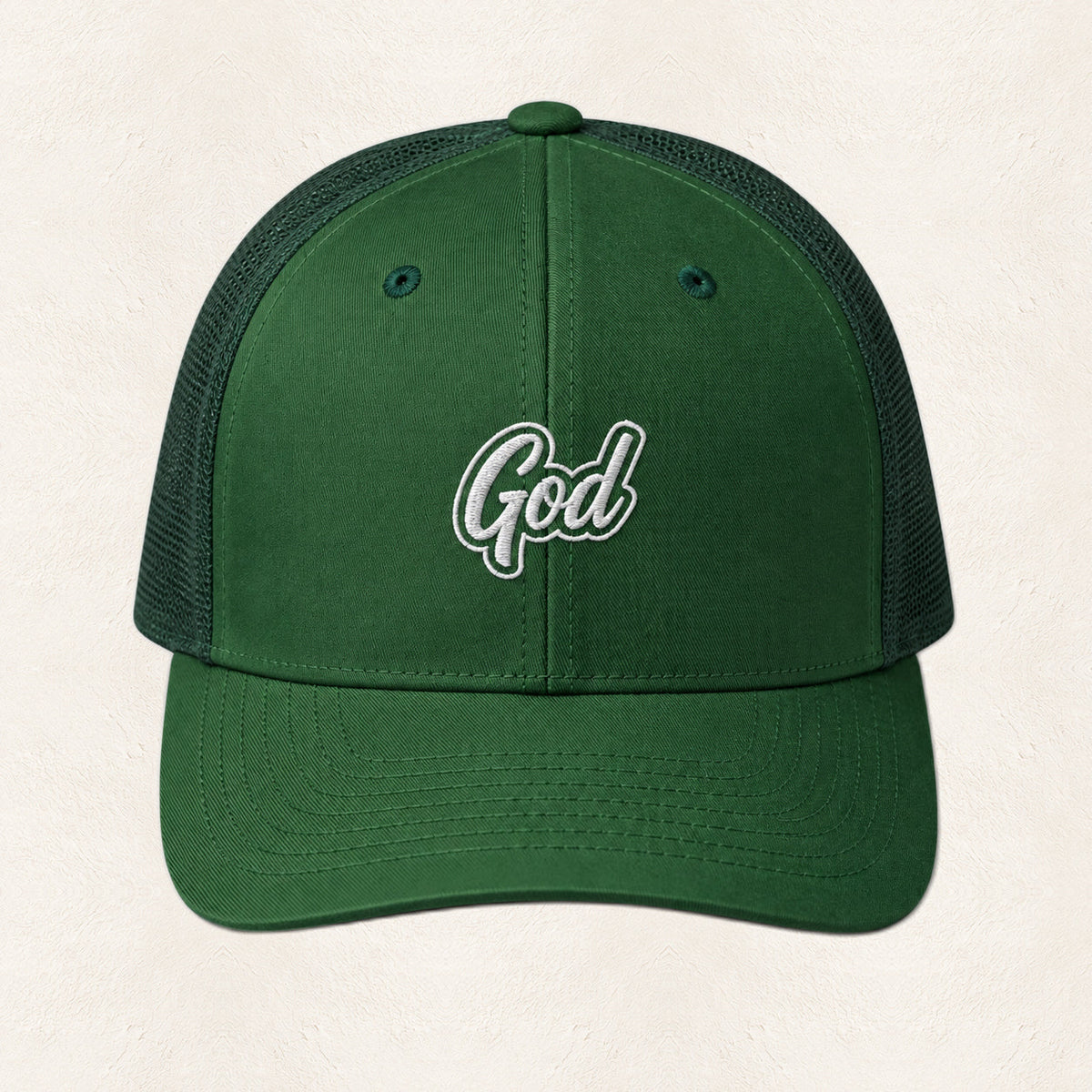 God Embroidered Trucker Hat — original product and design — warm ivory background
