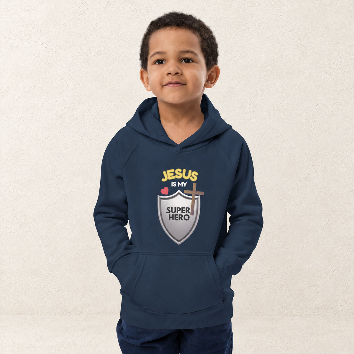 Jesus Is My Superhero Kids Hoodie — original child model — warm ivory textured background