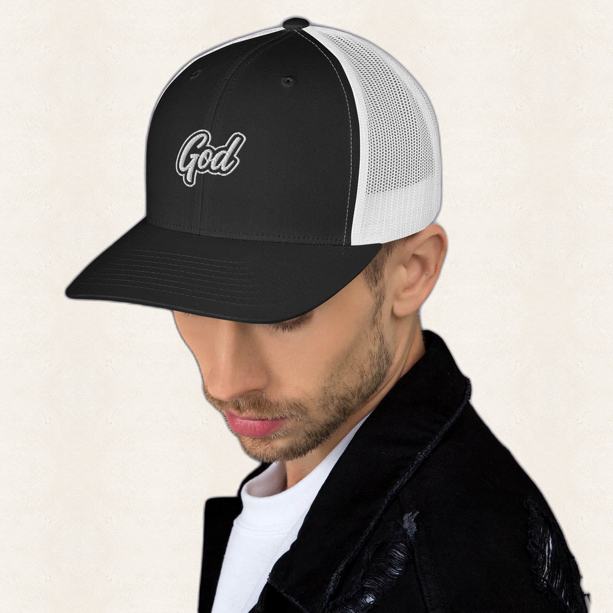 God Embroidered Trucker Hat — original product and design — warm ivory background